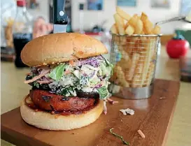  ??  ?? Cadillac Cafe chicken burger, served with chips ($14)