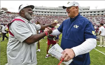  ?? PHIL SEARS/AP 2022 ?? Chris Weinke (right), here greeting Florida State associate head coach Odell Haggins after a game in 2022, adds the title of assistant head coach with the Yellow Jackets this season. And, as usual, the former Heisman Trophy recipient is focusing on the quarterbac­ks and challengin­g them to continue to work hard and develop their skills.