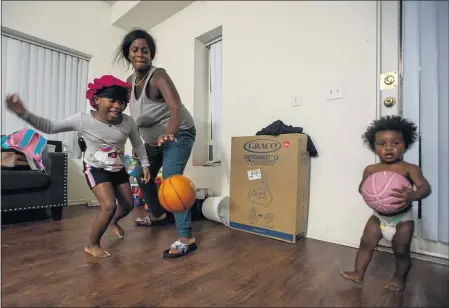  ??  ?? ABOVE: A pregnant Aysha-Samon Stokes, who played basketball in high school, plays ball with her children at home in downtown Los Angeles in April.