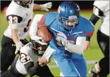  ?? DANA JENSEN/THE DAY ?? Waterford’s Dan Annibalini (10) fights for a few more yards against Montville’s Chris Connors (21) during Thursday’s high school football game. Waterford won the game, played on its home field, 37-19.