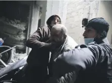  ??  ?? Abu Mohammed Alaya, 50, is helped out of the basement in which he takes shelter during air raids