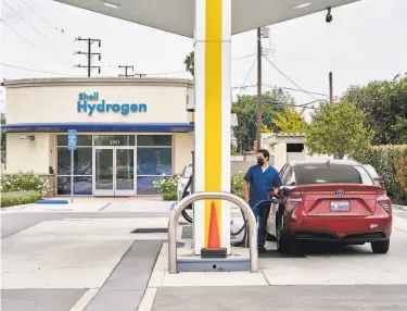  ?? Photos by Philip Cheung / New York Times ?? A motorist fills a hydrogenpo­wered Toyota Mirai at a fueling station in Torrance (Los Angeles County). The fuel could help fight climate change, but it has been slow to win acceptance because of high costs.