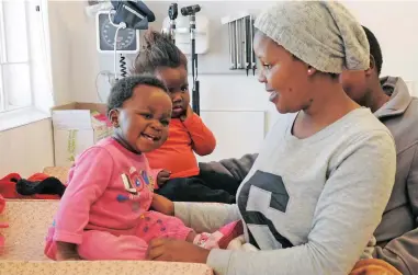  ?? PICTURE: TRACEY ADAMS ?? CLOSER TO HOME: Huwny Matoni, 1, with mom Bulelwa and Muhle Lize, 2, and mom Thotyelwa (hidden) at the opening of the R19m Nomzamo community day centre yesterday.