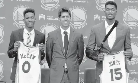  ?? DOUG DURAN/STAFF ?? Newest Warriors Patrick McCaw, left, and Damian Jones, right, hold up their jerseys as they pose with Golden State general manager Bob Myers on Friday.