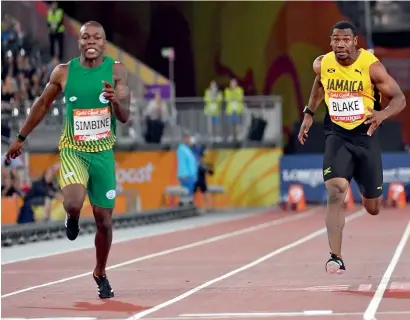  ?? — AFP ?? South Africa’s Akani Simbine (left) and Jamaica’s Yohan Blake cross the finish line in the men’s 100m final.