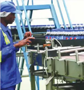  ??  ?? A worker in the production line of the Pepsi plant in Harare