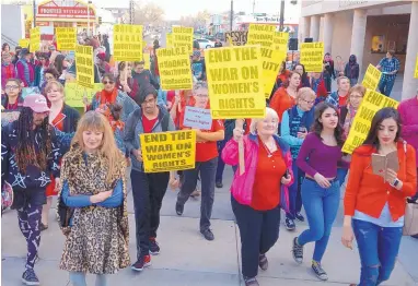  ?? GREG SORBER/JOURNAL ?? More than a hundred people gathered at the University of New Mexico to march in honor of Internatio­nal Women’s Day on Wednesday and to support the national women’s strike called A Day Without a Woman, in which women skipped work or showed solidarity by...
