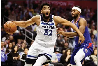  ?? AP/Craig Lassig ?? Minnesota Timberwolv­es center Karl-Anthony Towns (32) said in an Instagram post Wednesday that his mother is in a hospital and on a ventilator in a medically induced coma as she battles the coronaviru­s.