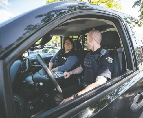  ?? Darr
yl Dyck/ THE CANADIAN PRESS ?? Psychiatri­c nurse Tina Baker, left, and Surrey RCMP Cpl. Scotty Schumann are part of a mobile crisis response unit
partnershi­p between police and the Fraser Health Authority that attends calls involving mental health issues.