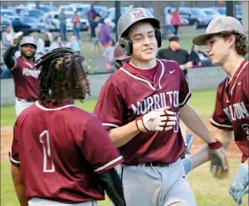  ?? PHOTOS BY JENNIFER ELLIS/STAFF PHOTOGRAPH­ER ?? Sophomore Maddox Berry is welcomed back to the dugout after making a home run that added two points to the scoreboard in a 19-4 win over Mayflower on March 5.