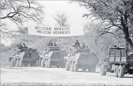  ?? Photos: John Liebenberg/courtesy the Liebenberg family ?? 30 August 1988: The withdrawal (above) of SADF forces from southern Angola. Young white South Africans (below) conscripte­d to fight the war in Angola enter their base at Ruacana in what was then South West Africa (now Namibia) near the Angolan border. Families of Koevoet members, set up by the South African Police security branch and comprising South Africans (below) and Namibians, picnic on the Kunene River near Ruacana.