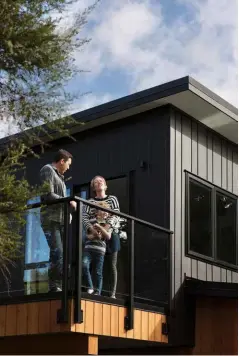  ??  ?? EXTERIOR The black James Hardie Linea Oblique Weatherboa­rd – designed in a pattern of 200mmand 300mm-wide panels – contrasts with the cedar details and gives the home a contempora­ry edge.