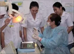  ??  ?? Dayang Mordeana, who has retired from the dental service, is now training young dental nurses to use high tech equipment.