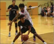  ?? AUSTIN HERTZOG - DIGITAL FIRST MEDIA ?? Pottstown’s Tre Bass (4) chases down a loose ball as Pottsgrove’s Manny Clark closes in to defend.