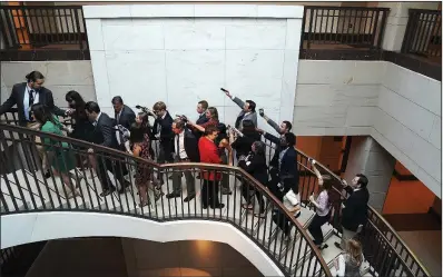  ?? The New York Times/ERIN SCHAFF ?? Sen. Joe Manchin (fifth from left) talks with reporters Thursday after leaving the secure room where he viewed the FBI report on Brett Kavanaugh. Manchin, a Democrat from West Virginia who has not declared how he will vote on the Supreme Court nominee, said he would resume reading the report today.