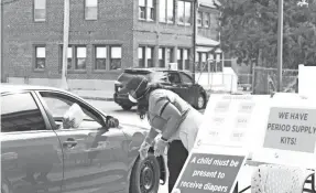  ??  ?? During the coronaviru­s lockdowns, St. Louis County Library turned its parking lots into sites for community giveaways.