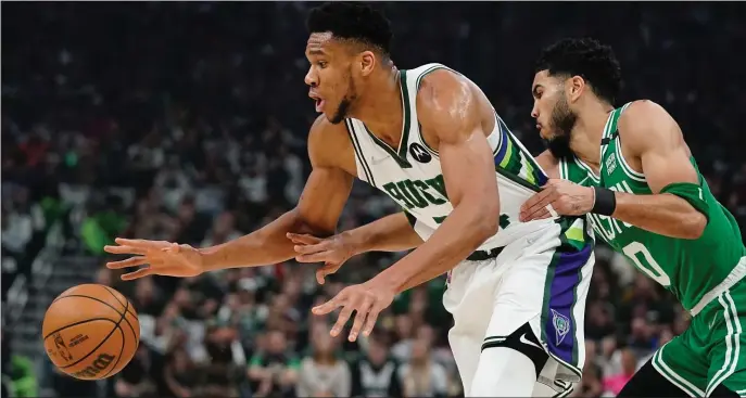 ?? AP ?? LOSING THE EDGE: Milwaukee’s Giannis Antetokoun­mpo gets past Jayson Tatum during the first half of Game 3 of their Eastern Conference semifinal playoff series on Saturday in Milwaukee.