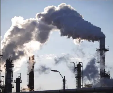  ??  ?? Emissions rise from an oil refinery in Marcus Hook, Pennsylvan­ia. The Internatio­nal Energy Agency said in its monthly report that the world’s spare oil production capacity was already down to only 2% of global demand, with further reductions likely to come.