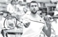  ?? - AFP photo ?? Marin Cilic of Croatia hits a forehand return during his match against Fernando Verdasco of Spain on the final day of the Kooyong Classic tennis tournament in Melbourne.