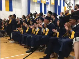  ??  ?? Students applaud as they listen during commenceme­nt ceremonies.