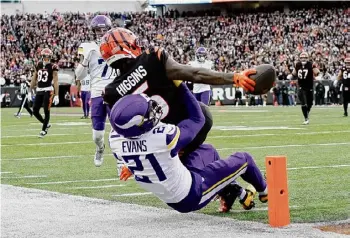  ?? Carolyn Kaster/Associated Press ?? Bengals wide receiver Tee Higgins reaches for the end zone to score a touchdown against Vikings cornerback Akayleb Evans on Saturday in Cincinnati.