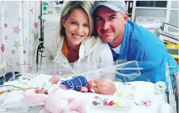  ??  ?? GROWING BEAUTIFULL­Y: Baby Tayla’s parents, Elrize Kruger and Jason Christie, spending some one-on-one time with their tiny daughter.