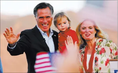  ?? Rickbowmer ?? The Associated Press Former GOP presidenti­al nominee Mitt Romney holds his grandson Dane Romney, 2, while he and his wife Ann wave after addressing supporters Tuesday in Orem, Utah. Romney on Tuesday won the Republican primary for a Utah U.S. Senate...