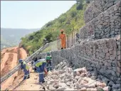  ??  ?? ROCK SOLID: Workers prepare gabions on the awardwinni­ng stretch of the Dumisani Makhaye Freeway.