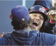  ?? AP PHOTO ?? NATIONAL PRIDE: Ian Kinsler celebrates his home run with a teammate during Team USA’s championsh­ip victory in the World Baseball Classic last night; below, Marcus Stroman gets congratula­tions from Jonathan Lucroy.