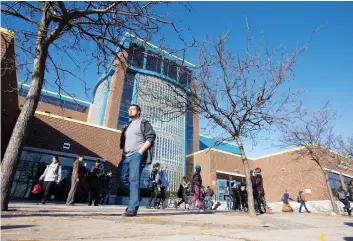  ?? CRAIG GLOVER/LONDON FREE PRESS ?? Students file out of H.B. Beal Secondary School at the end of the day in London, Ont. With the cash-strapped Thames Valley District School Board on the hook for covering the full ride for those students taking a victory lap, trustees decided Tuesday...