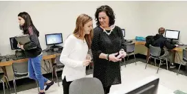  ?? [PHOTO BY MATT BARNARD, TULSA WORLD] ?? English teacher Sara Eagleton, right, talks Thursday with junior MacKenzie Higgins after a session in the computer lab at Inola High School.