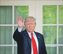  ?? AP PHOTO ?? U.S. President Donald Trump waves as he returns to the Oval Office of the White House in Washington after speaking about the U.S. role in the Paris climate change accord.