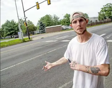  ?? Clem Murray/Philadelph­ia Inquirer ?? Eric Jackson, 31, of South Philadelph­ia waits at the bus stop across from the Philadelph­ia prison complex on State Road earlier this month and discusses the living conditions inside the House of Correction­s during a heat wave. Mr. Jackson had been...