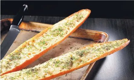  ?? ABEL URIBE/ CHICAGO TRIBUNE/TNS ?? The warm garlic bread is finished with fresh herbs, like sage, thyme, chives and oregano.