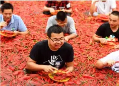  ??  ?? Contestant­s taking part in a chilli pepper-eating competitio­n in Ningxiang. — AFP photo