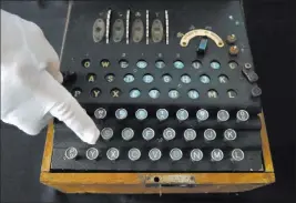  ?? Jacquelyn Martin ?? The Associated Press H. Keith Melton points to a key on an Enigma Machine, one of the many items he is donating, on Wednesday in Washington. The machine was used in World War II to encode messages.