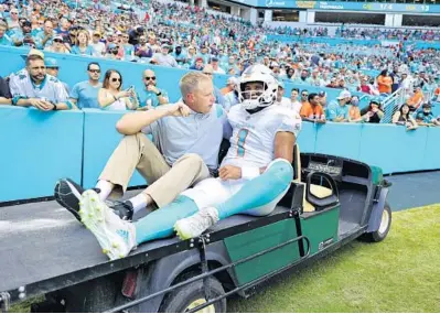  ?? DAVID SANTIAGO/MIAMI HERALD VIA AP ?? Miami Dolphins quarterbac­k Tua Tagovailoa is carted off the field after suffering a rib injury during the first half of Miami’s game against the Buffalo Bills on Sunday in Miami Gardens. The Bills beat the Dolphins 35-0. See story in