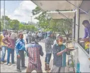  ??  ?? Needy people wait in a queue to collect free food, being provided by the Telangana government in Hyderabad, Sunday. PTI