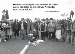  ?? Associated Press ?? ■ People protesting the constructi­on of the Dakota Access oil pipeline block a highway Wednesday near Cannon Ball, N.D.