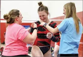  ?? PILOT PHOTO/RUDY MARQUEZ ?? Jersey Hunter was emotional after performing a new skill on the bars. Coach Mandy Bender and teammate Piper Frank congratula­te her. She scored 8.55, enough for second place at the last home meet of the season.