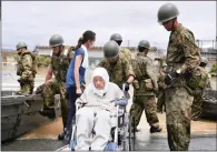  ?? PICTURES: KYODO NEWS/AP ?? An elderly person is rescued from a flooded Kurashiki city in the Okayama prefecture, south-western Japan, yesterday. Heavy rainfall hit southern Japan for the third day, prompting new disaster warnings on Kyushu and Shikoku islands.