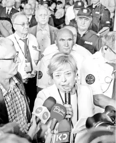  ??  ?? File photo shows Gersdorf (centre) is surrounded by media and supporters as she arrives for work at the Supreme Court building in Warsaw. — AFP photo