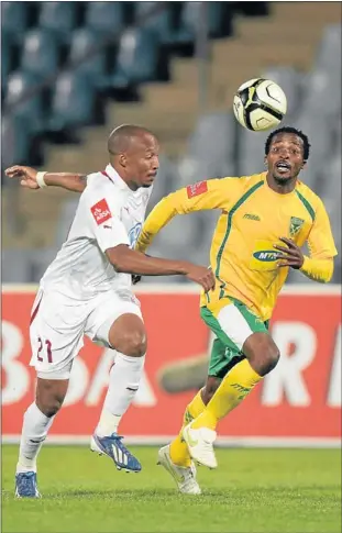  ?? PHOTO: GALLO IMAGES ?? TOP OF THE CHARTS: Moroka Swallows striker Katlego Mashego, left, is challenged by Golden Arrows’ Joseph Musonda during their Premiershi­p match at Dobsonvill­e Stadium in Soweto