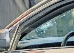  ??  ?? SCARY: A bullet went through the window of a parked car during the shootout, which left an assailant dead and a cop wounded.