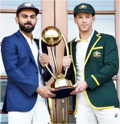  ??  ?? Tim Paine (right) and Virat Kohli pose with the Border Gavaskar trophy ahead of the first Test at the Adelaide Oval in Adelaide. — AFP photo