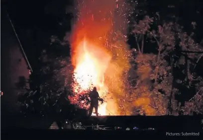  ??  ?? The fire at Broad Oak Way in Cheltenham. Mark Consterdin­e is pictured on top of his shed
Pictures: Submitted