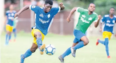  ?? PHOTOS BY GLADSTONE TAYLOR/MULTIMEDIA PHOTO EDITOR ?? Hydel High School’s Chad-Andre Jenkins (left) in flight as he dribbles towards goal against Vauxhall High School during their ISSA Walker Cup fixture played at the Spanish Town Prison Oval on Friday, November 8, 2019.