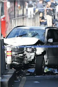  ?? JOE CASTRO / AAP IMAGE VIA THE ASSOCIATED PRESS ?? A damaged vehicle is seen on Flinders Street, in Melbourne on Thursday after a car drove into pedestrian­s on a sidewalk in the Australian city.