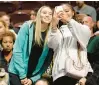  ?? JESSICA HILL/AP ?? Connectiut women’s basketball player Paige Bueckers poses for a selfie with a fan during Game 4 of the WNBA playoff semifinal between the Sun and the Chicago Sky on Sept. 6 in Uncasville.