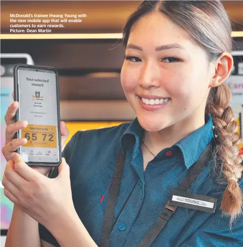  ?? ?? McDonald’s trainee Hwang Young with the new mobile app that will enable customers to earn rewards.
Picture: Dean Martin